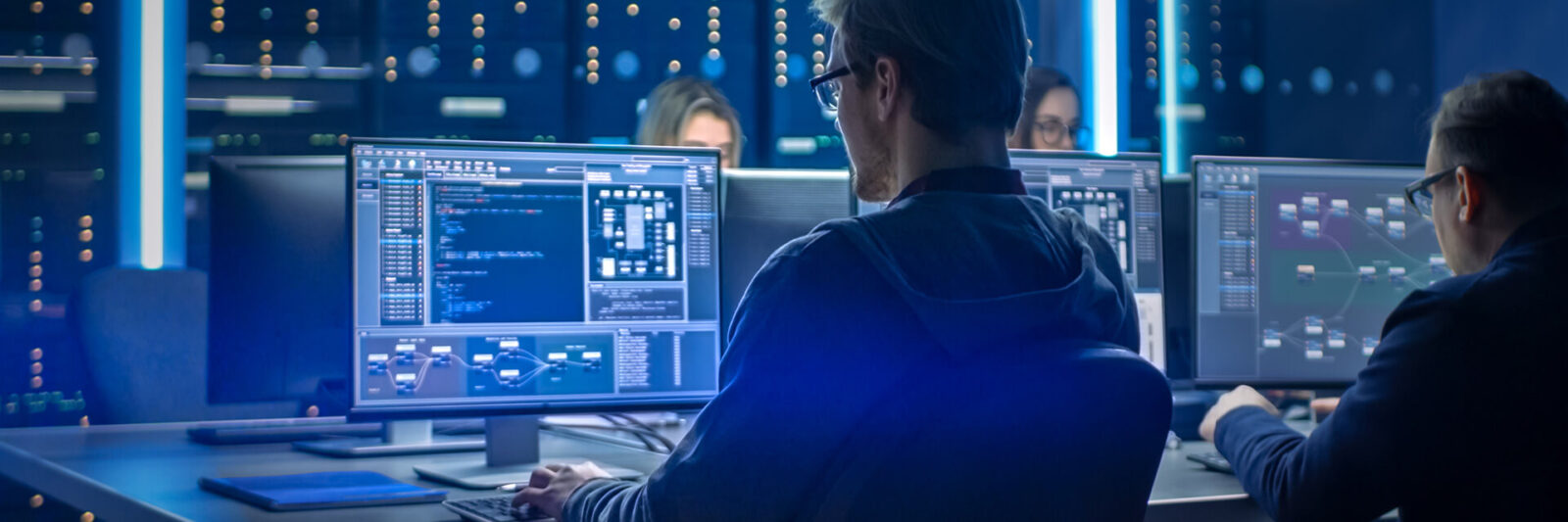 Image of people working on computers in a command center