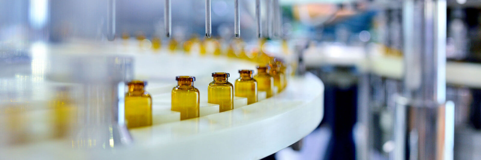 Image of bottles being filled in an assembly line.