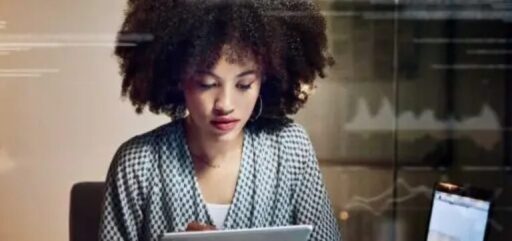 Female QA manager performing software testing for compliance standards.